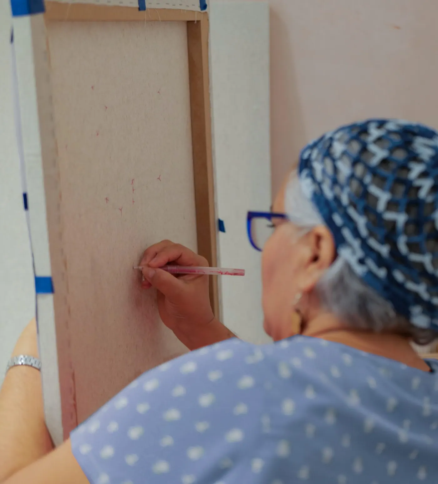 Artisan reviewing a finished panel by hand